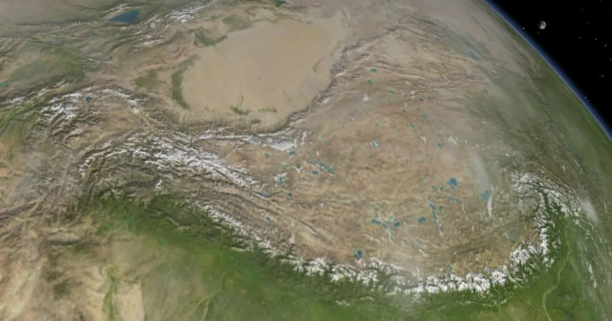 Satellite view of the Earth's land surface, mountains and arid terrain seen from orbit against the curve of the planet.